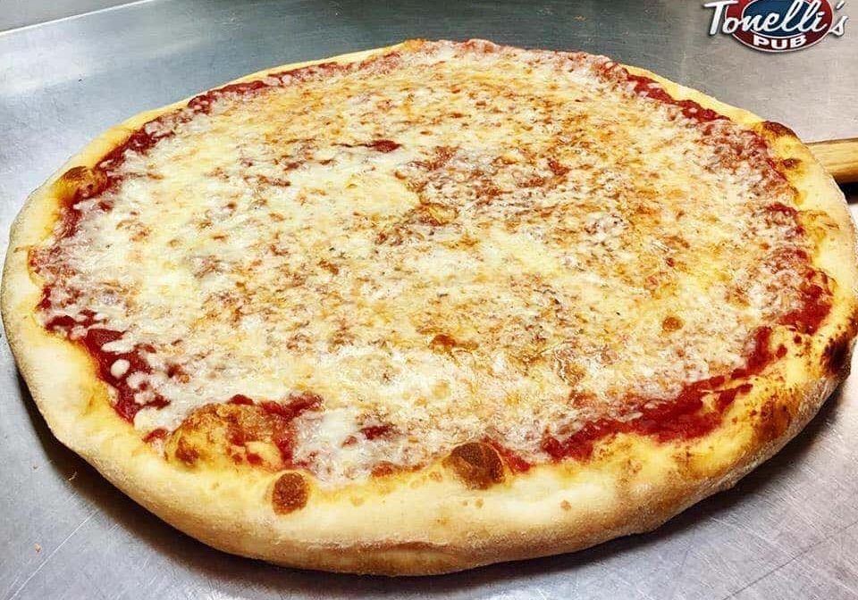 A pizza sitting on a counter top.